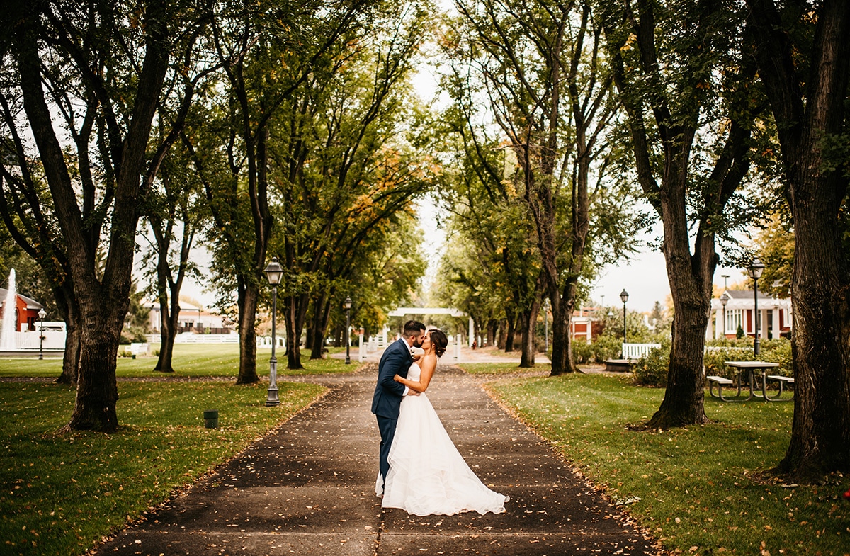 Bride and groom kissing at Earle Brown Heritage Center