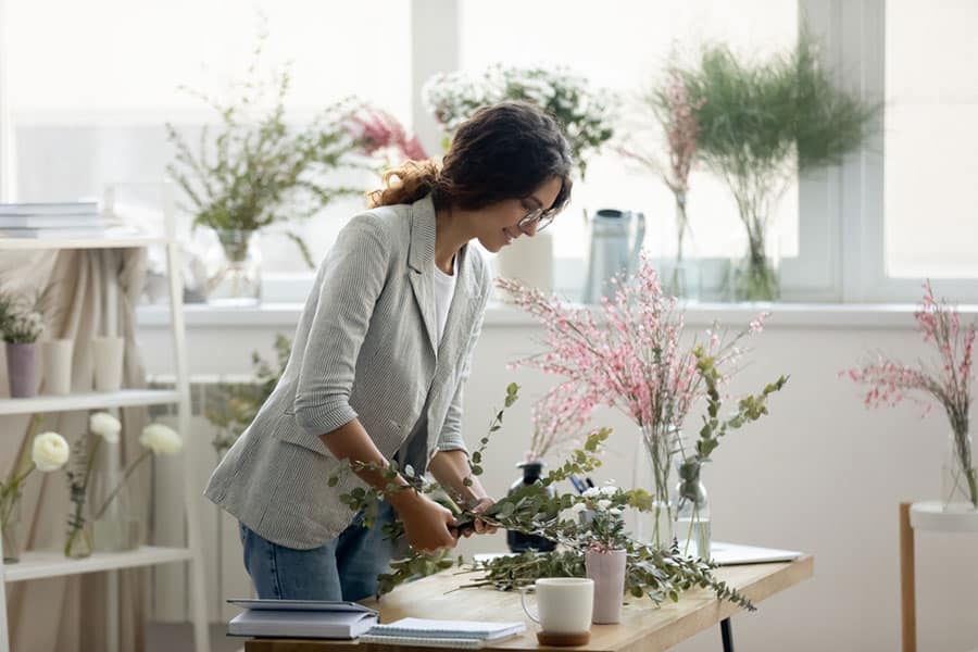 Woman with wedding floral arrangements