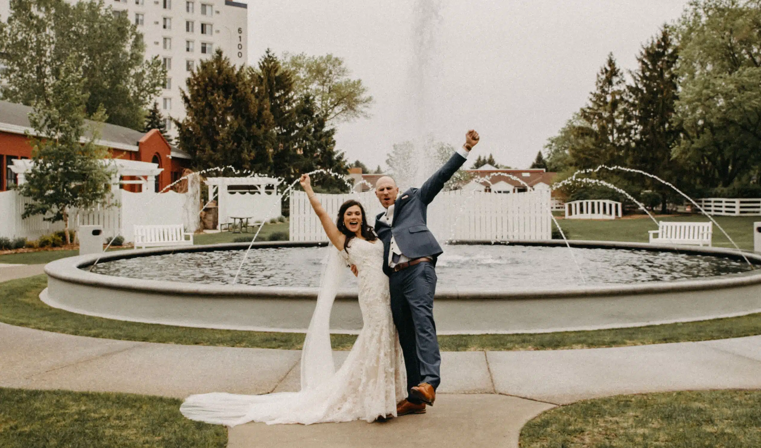 Couple celebrating by the Heritage Center fountain